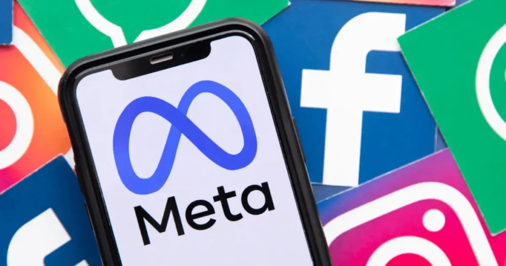 Meta logo displayed on smartphone screen with Facebook Instagram and WhatsApp app icons in background