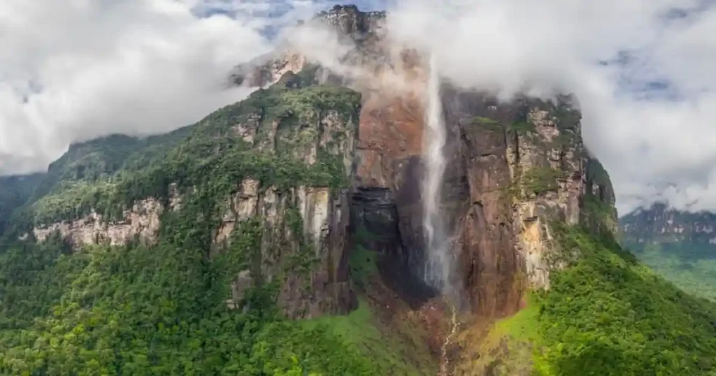 Angel Falls Venezuela top view with clouds surrounding waterfall as water turns into mist before reaching ground