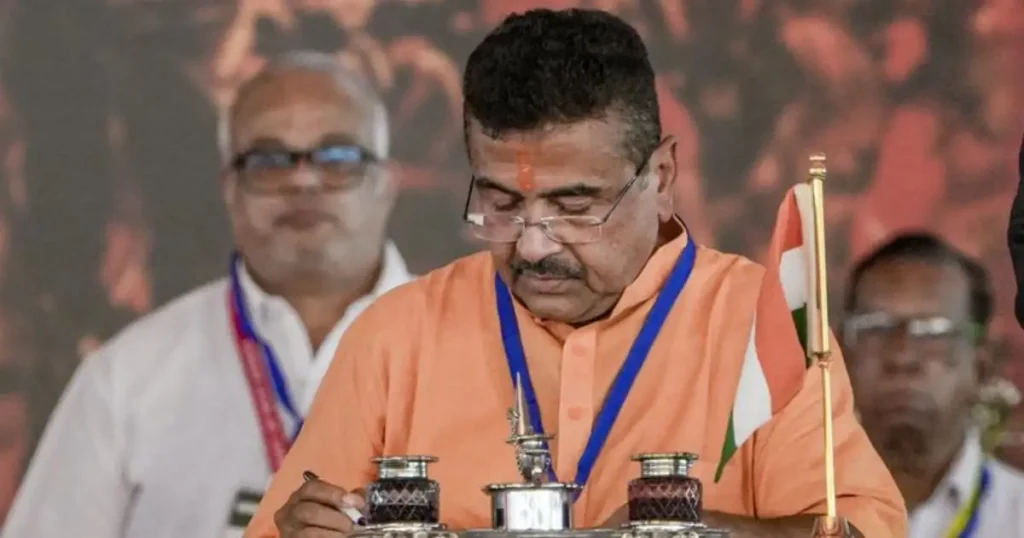 Suvendu Adhikari attending political event and signing documents during BJP meeting in West Bengal