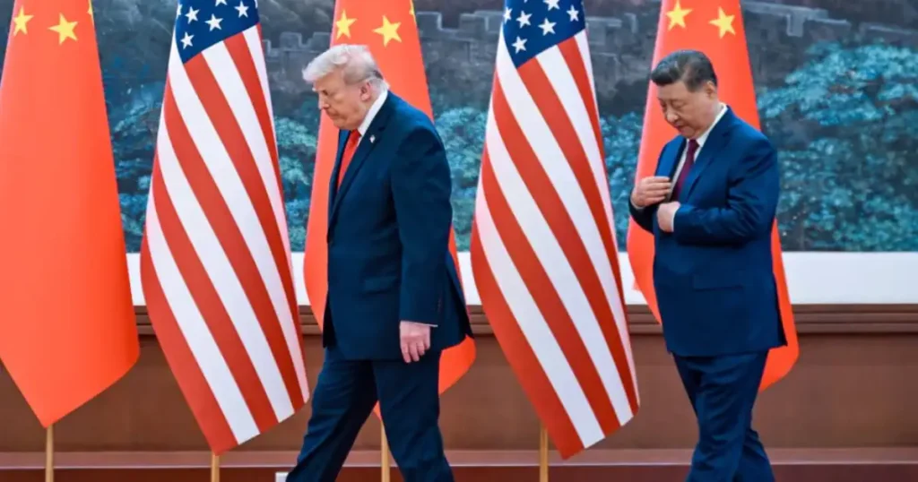 Donald Trump and Xi Jinping walk past US and China flags after Beijing summit talks on trade and Taiwan issues