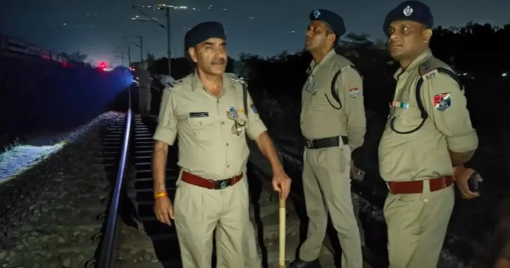 RPF personnel inspect the railway track at night after the Ujjaini Express derailment incident in Rishikesh